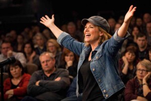 Confident Woman Before A Large Disappointed Audience